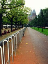 Many bike racks along a park in Amsterdam. Photo by Jym Dyer.